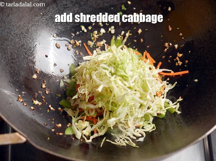 Step 10 – Add &frac12; cup <a href="https://www.tarladalal.com/glossary-shredded-cabbage-763i">shredded cabbage</a>.