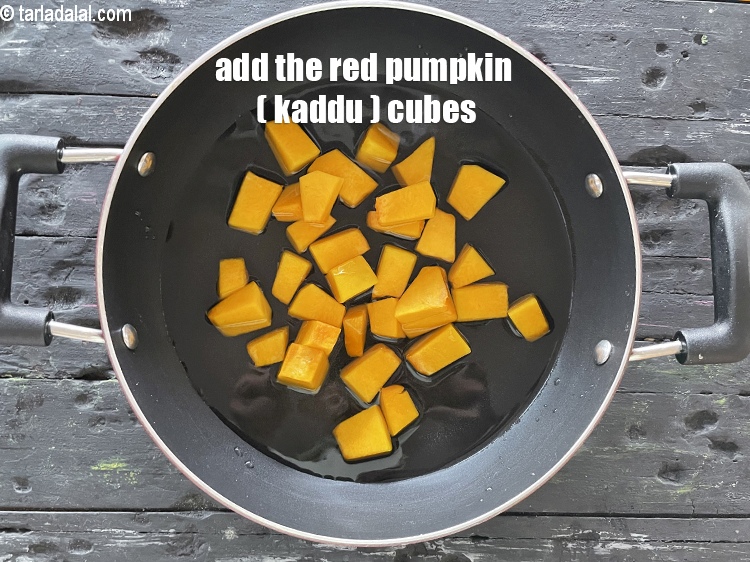 Step 12 – Add&nbsp;put&nbsp;<!--%3Cmeta%20charset%3D%22UTF-8%22%20%2F%3E-->1 cup&nbsp;<a href="glossary-red-pumpkin-cubes-1530i">red pumpkin (bhopla / kaddu) cubes</a>.