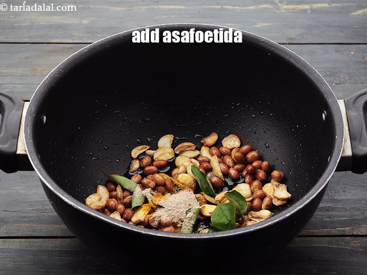 Step 10 – Add the <a href="https://www.tarladalal.com/glossary-asafoetida-hing-113i" target="_blank">asafoetida</a>.
