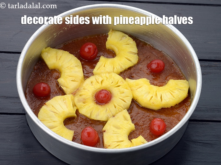 Step 10 – Decorate the sides with <a href="https://www.tarladalal.com/glossary-pineapple-ananas-88i">pineapple</a>&nbsp;halves as show in the image.&nbsp;