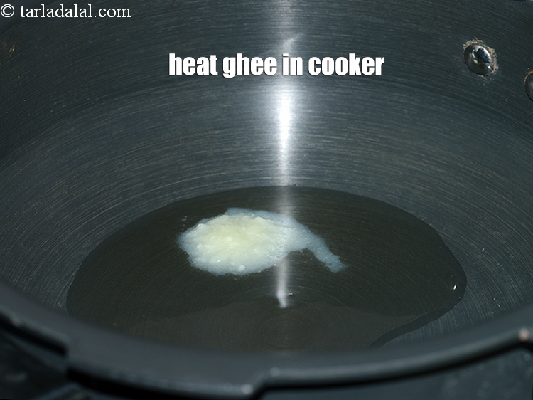 Step 11 – Heat 2 tsp ghee in a pressure cooker.