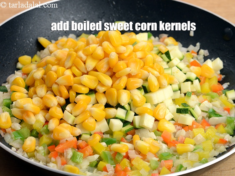 Step 13 – Add &frac12; cup <a href="https://www.tarladalal.com/glossary-boiled-sweet-corn-kernels-153i">boiled sweet corn kernels (makai ke dane)</a>.