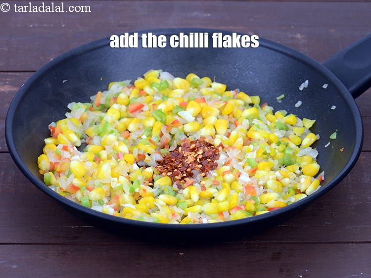 Step 10 – Add 1 tsp&nbsp;<a href="https://tarladalal.com/glossary-dry-red-chilli-flakes-paprika-338i">dry red chilli flakes (paprika)</a>.&nbsp;