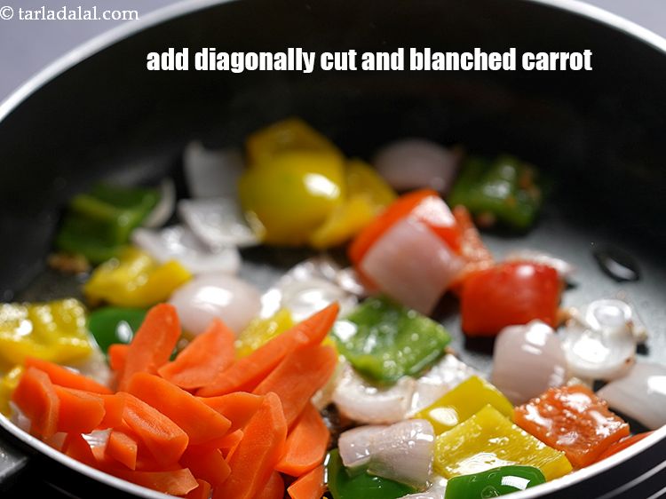 Step 18 – Add 1/2 cup&nbsp;diagonally cut and&nbsp;<a href="https://www.tarladalal.com/glossary-blanched-carrot-1839i">blanched carrot</a>.&nbsp;