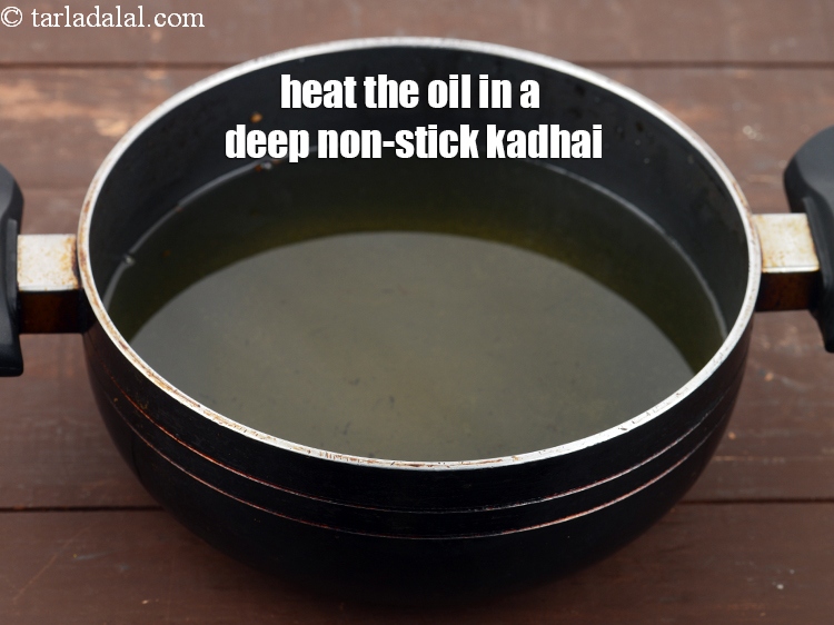 Step 21 – Heat the <a href="https://www.tarladalal.com/glossary-oil-671i">oil</a>&nbsp;in a deep non-stick kadhai.&nbsp;