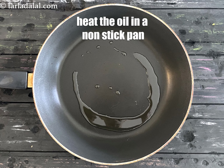 Step 11 – Heat 1 tablespoon oil in a broad non-stick pan.