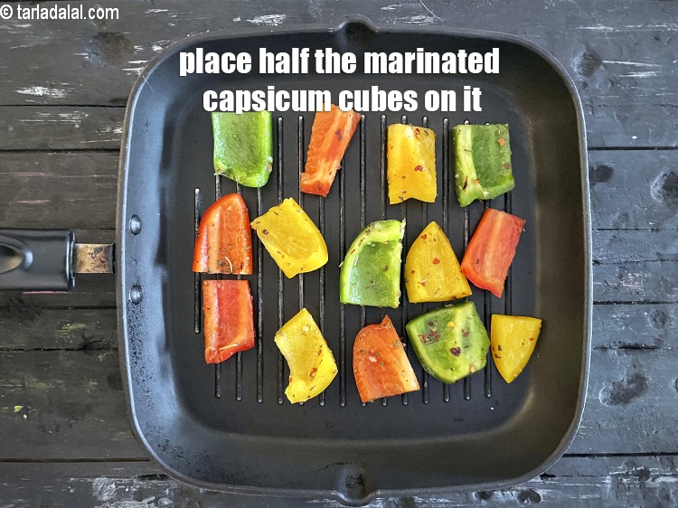 Step 11 – Arrange half the marinated capsicum strips on it.