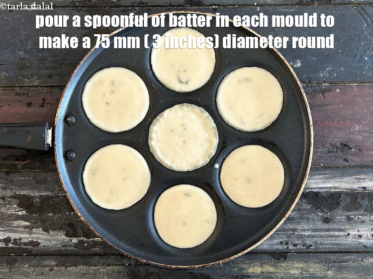 Step 10 – <meta charset="UTF-8" />Pour a spoonful of batter in each uttapa mould to make a 75 …