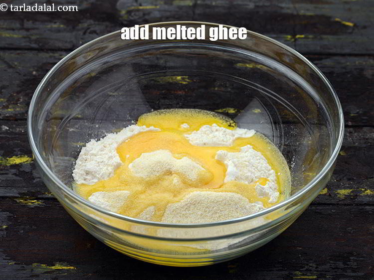 Step 12 – Add the <a href="https://www.tarladalal.com/glossary-ghee-245i" target="_blank">melted ghee</a>.
