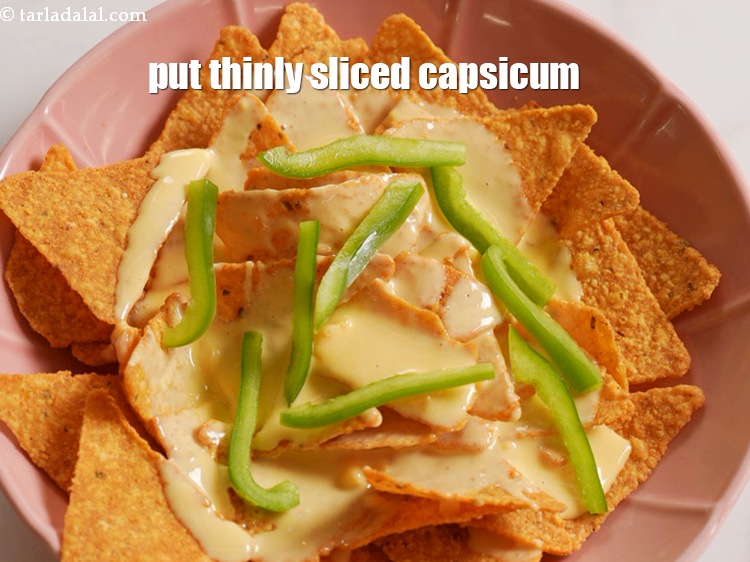 Step 26 – Put thinly&nbsp;<a href="https://www.tarladalal.com/glossary-sliced-capsicum-165i">sliced capsicum</a>.&nbsp;