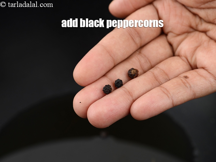Step 11 – Add 2 to 3 <a href="https://www.tarladalal.com/glossary-black-peppercorns-kali-mirch-kalimirch-566i">black peppercorns (kalimirch)</a>.