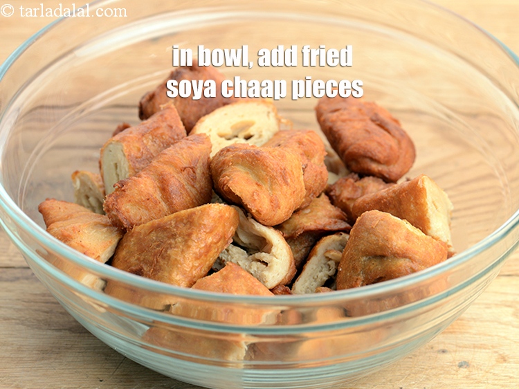 Step 13 – For the first marination, in a deep bowl, add the fried soya chaap pieces.