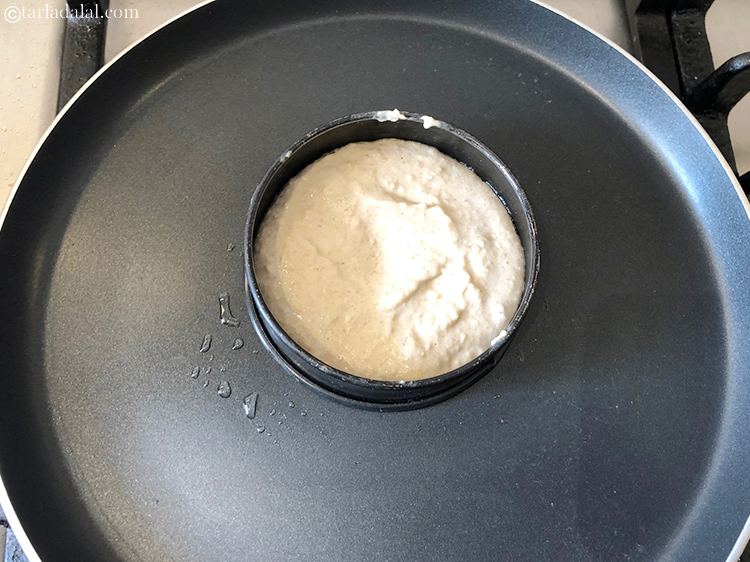 Step 10 – Pour 1/4 th the batter on the greased loose bottom tin and cook on medium …