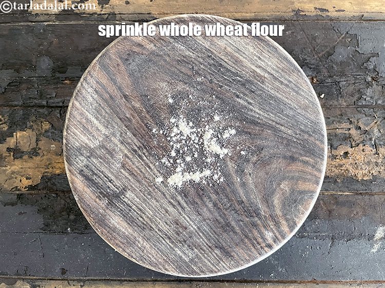 Step 21 – <span style="font-size:12px"><span style="color:#000000"><span style="font-family:Helvetica"><span style="background-color:#ffffff"><span style="font-family:Arial,Helvetica,sans-serif"><span style="font-size:medium">Sprinkle a little&nbsp;whole wheat flour on the rolling surface.</span></span></span></span></span></span>&nbsp;