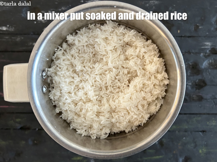 Step 11 – In a mixer put&nbsp;<meta charset="UTF-8" />2 cups&nbsp;raw&nbsp;<a href="glossary-rice-chawal-533i">rice (chawal)</a>&nbsp;, soaked for 4 hours , drained.