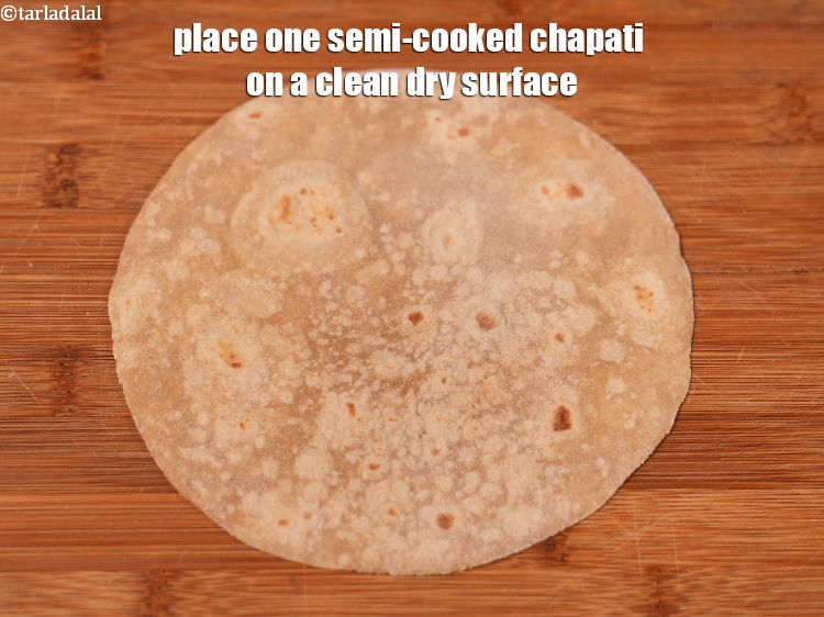 Step 11 – Place one semi-cooked chapati on a clean dry surface.
