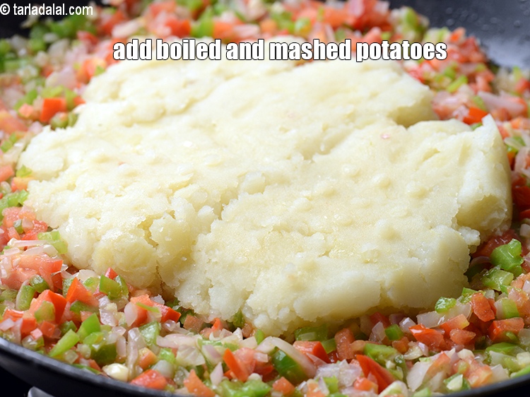 Step 12 – Add 1 cup boiled and <a href="https://www.tarladalal.com/glossary-boiled-and-mashed-potatoes-1831i">mashed potatoes</a>.&nbsp;