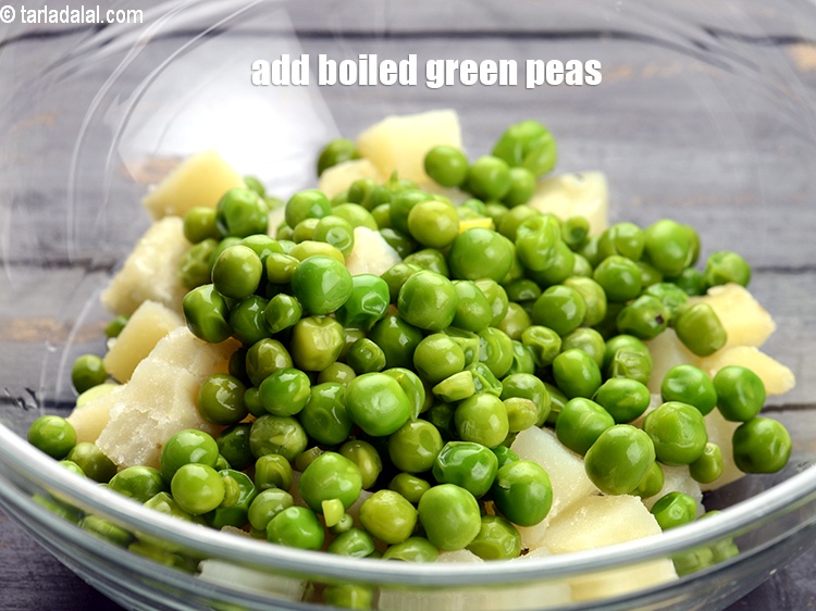 Step 11 – Add 1/2 cup <a href="https://tarladalal.com/glossary-boiled-green-peas-1078i">boiled green peas</a>.