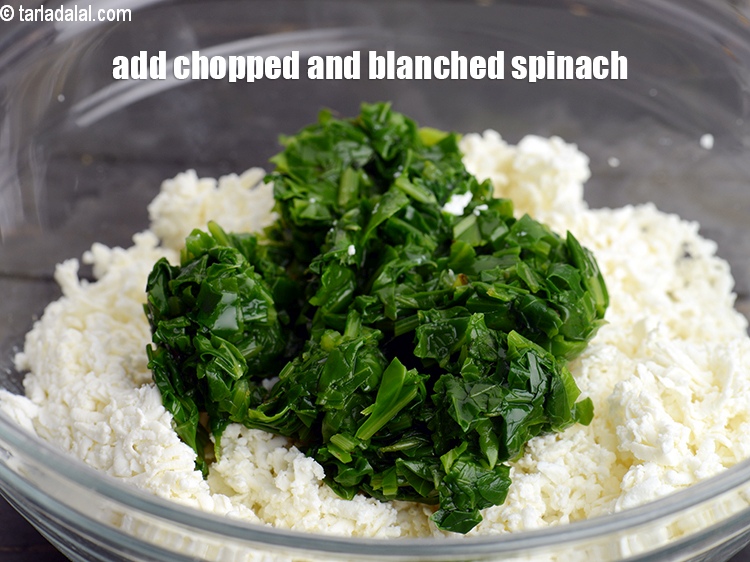 Step 13 – Add &frac12; cup chopped and <a href="https://www.tarladalal.com/glossary-blanched-spinach-727i">blanched spinach (palak)</a>.