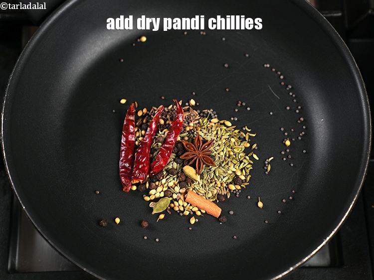 Step 11 – Add 2 dry&nbsp;<a href="https://www.tarladalal.com/glossary-pandi-chillies-pandi-dry-red-chillies-2373i">pandi chillies</a>.