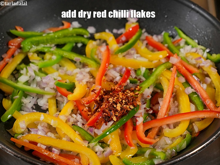 Step 11 – Add 1 tsp <a href="https://www.tarladalal.com/glossary-dry-red-chilli-flakes-paprika-338i">dry red chilli flakes (paprika)</a>.