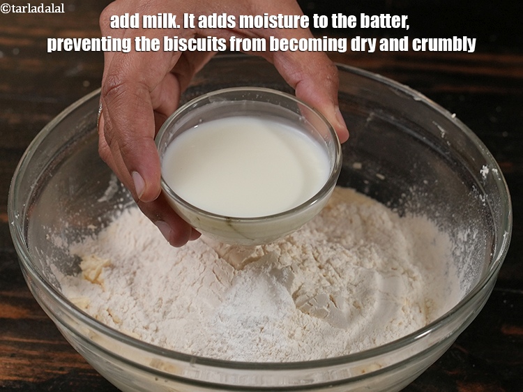 Step 11 – Add 1/3 cup <a href="https://www.tarladalal.com/glossary-milk-doodh-full-cream-milk-514i">milk</a>. It adds moisture to the batter, preventing the biscuits from …