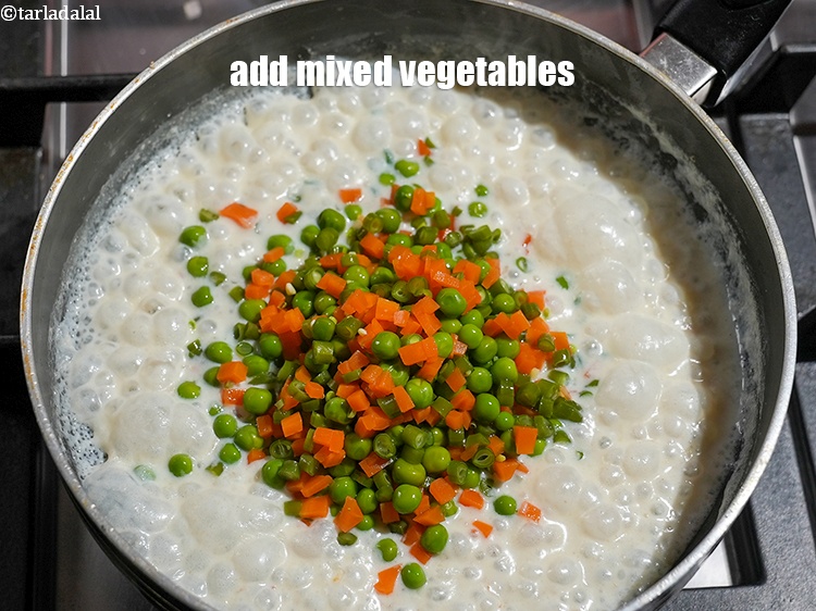 Step 17 – Add &frac34; cup <a href="https://www.tarladalal.com/glossary-chopped-and-boiled-mixed-vegetables-1884i">chopped and boiled mixed vegetables</a>.