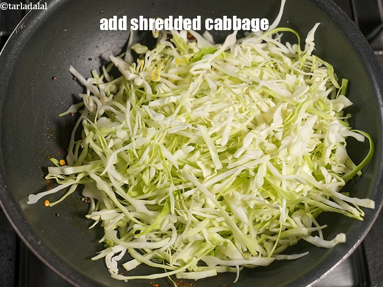 Step 11 – Add 2 &frac12; cups&nbsp;<a href="https://www.tarladalal.com/glossary-shredded-cabbage-763i">shredded cabbage</a>.