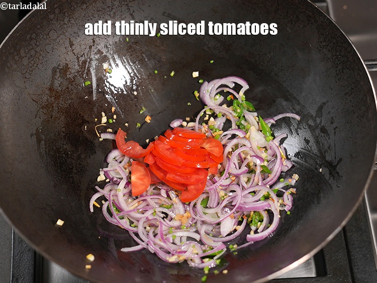 Step 14 – Add &frac14; cup thinly <a href="https://www.tarladalal.com/glossary-sliced-tomatoes-746i">sliced tomatoes</a>.&nbsp;