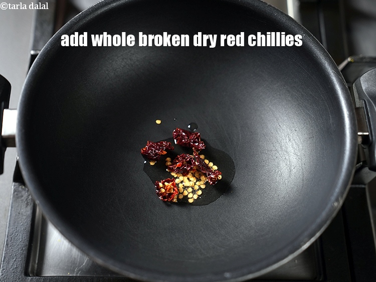 Step 16 – Add 1 whole broken dry red chillies.&nbsp;