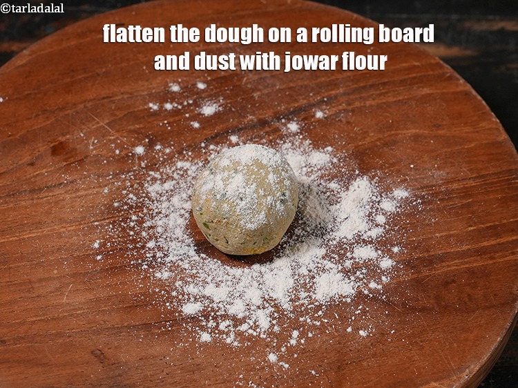 Step 14 – <meta charset="UTF-8" /> Flatten the dough on a rolling board and dust with jowar flour.&nbsp;