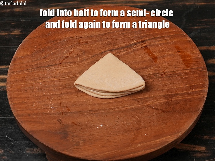 Step 14 – Fold into half to form a semi- circle and fold again to form a triangle.