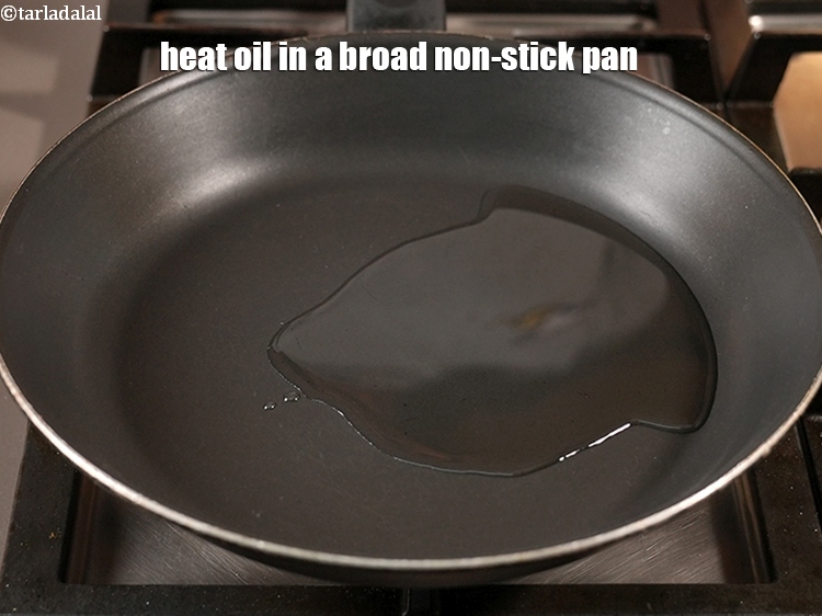 Step 11 – Heat 2 tbsp <a href="https://www.tarladalal.com/glossary-oil-671i">oil</a> in a broad non-stick pan.