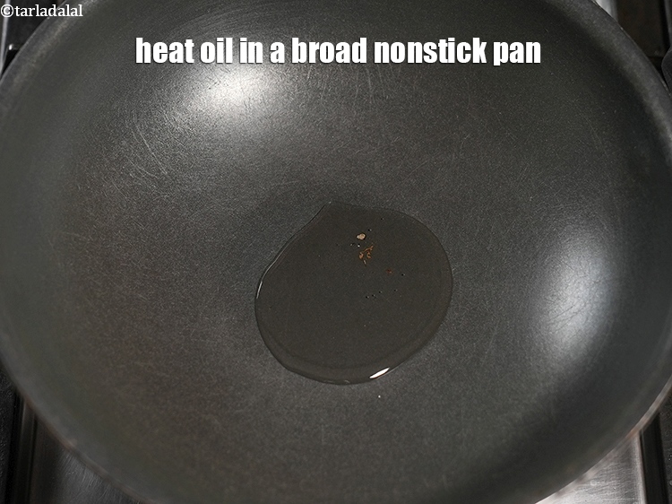 Step 11 – Heat 2 tsp oil in a broad nonstick pan.