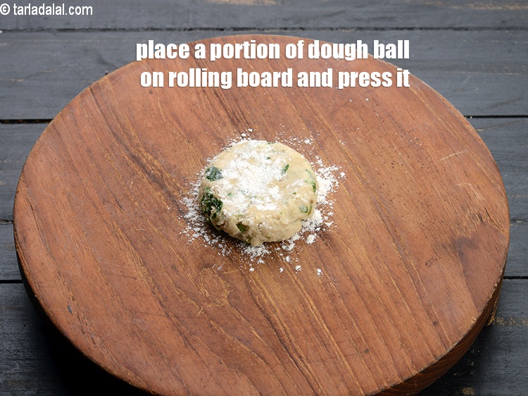 Step 11 – Place a portion of dough ball on rolling board and press it.