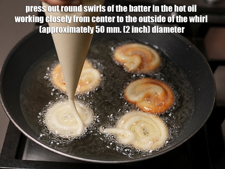 Step 17 – Press out round swirls of the batter in the hot oil working closely from center …