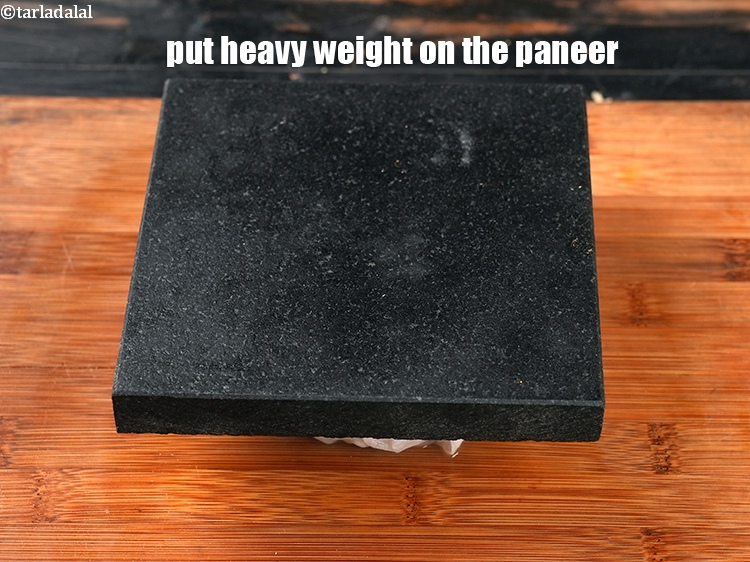 Step 11 – Put heavy weight on the paneer and keep aside for 30 minutes.