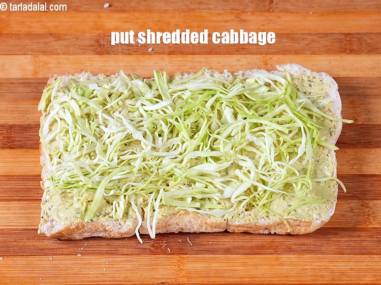 Step 14 – Put &frac14; cup <a href="https://www.tarladalal.com/glossary-shredded-cabbage-763i">shredded cabbage</a>.