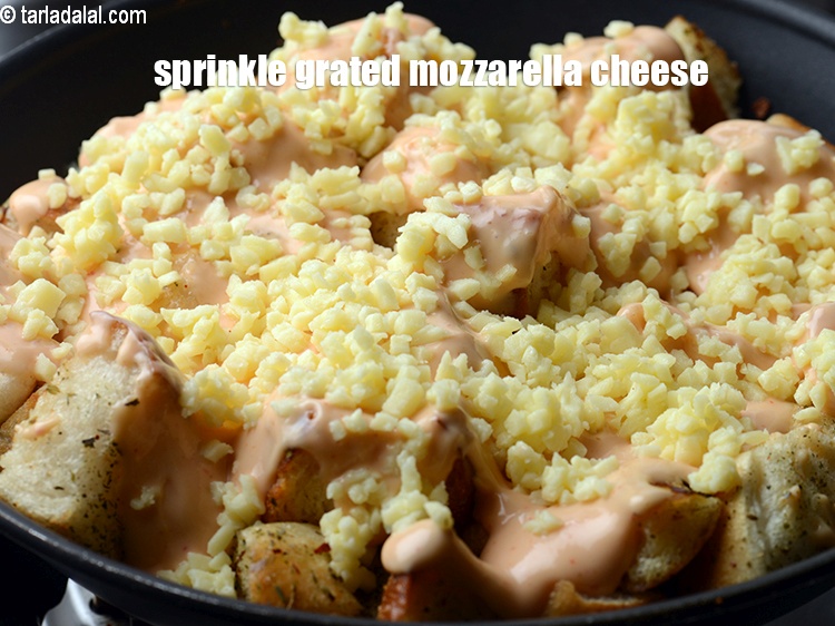 Step 12 – Finally sprinkle &frac12; cup&nbsp;<a href="https://www.tarladalal.com/glossary-grated-mozzarella-cheese-1022i">grated mozzarella cheese</a>. &nbsp;