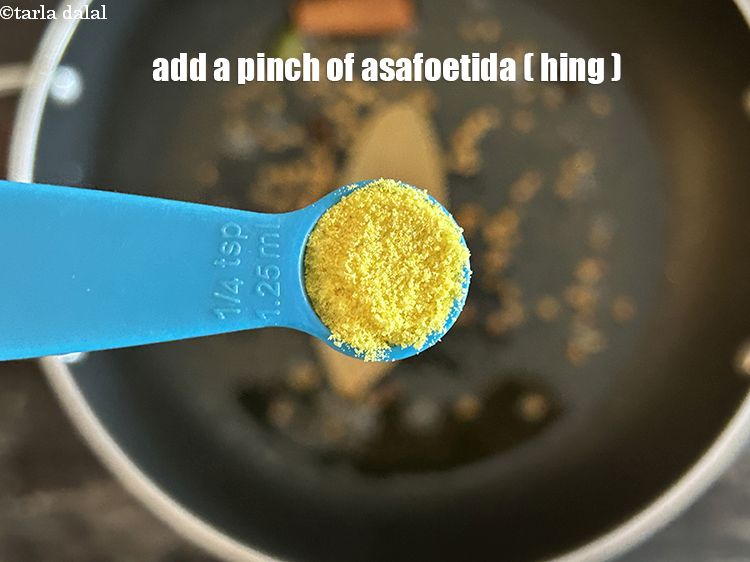 Step 11 – Add&nbsp;<meta charset="UTF-8" />a pinch of&nbsp;<a href="glossary-asafoetida-hing-113i">asafoetida (hing)</a>.