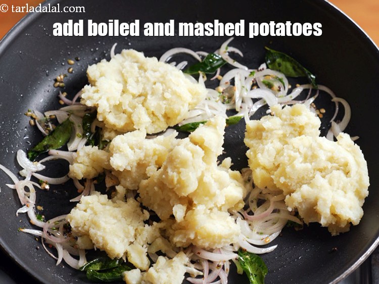 Step 12 – Add 1 1/4 cups boiled and <a href="https://www.tarladalal.com/glossary-boiled-and-mashed-potatoes-1831i">mashed potatoes</a>.