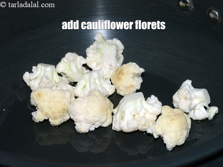 Step 12 – Add &frac12; cup <a href="https://www.tarladalal.com/glossary-cauliflower-florets-753i">cauliflower florets</a>.