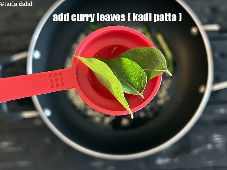 Step 17 – <html><head></head><body><p>Add&nbsp;2 to 3&nbsp;<a href="glossary-curry-leaves-kadi-patta-kadipatta-388i">curry leaves (kadi patta)</a>.</p></body></html>