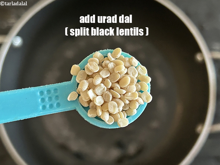 Step 12 – Add&nbsp;<meta charset="UTF-8" />1/2 tsp&nbsp;<a href="glossary-urad-dal-split-black-lentil-941i">urad dal (split black lentils)</a>.