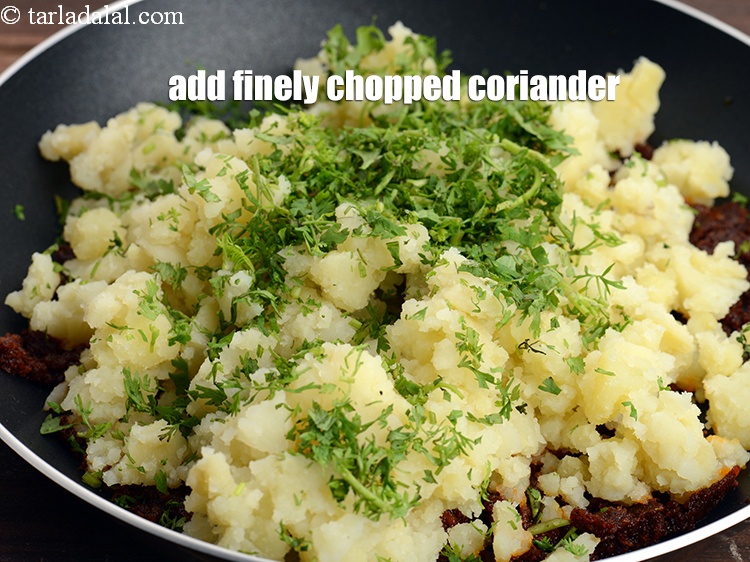 Step 11 – Add 2 tbsp finely <a href="https://www.tarladalal.com/glossary-chopped-coriander-783i">chopped coriander (dhania)</a>.