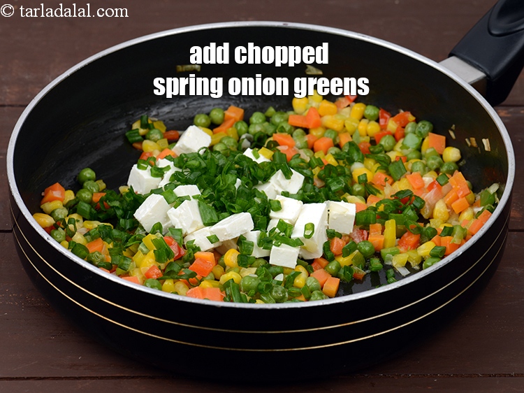 Step 10 – Add 2 tbsp&nbsp;<a href="https://tarladalal.com/glossary-chopped-spring-onion-greens-1030i">chopped spring onion greens</a>.&nbsp;