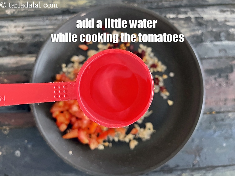 Step 11 – Add a little water. We gradually added 1/4 cup water while cooking the tomatoes.