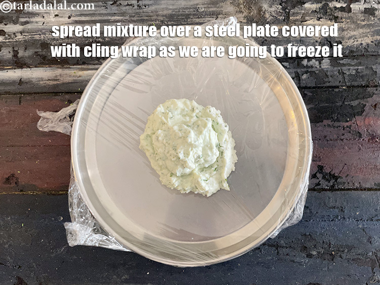 Step 12 – Spread paneer mixture over plastic film or cling wrap. We put the cling wrap over …