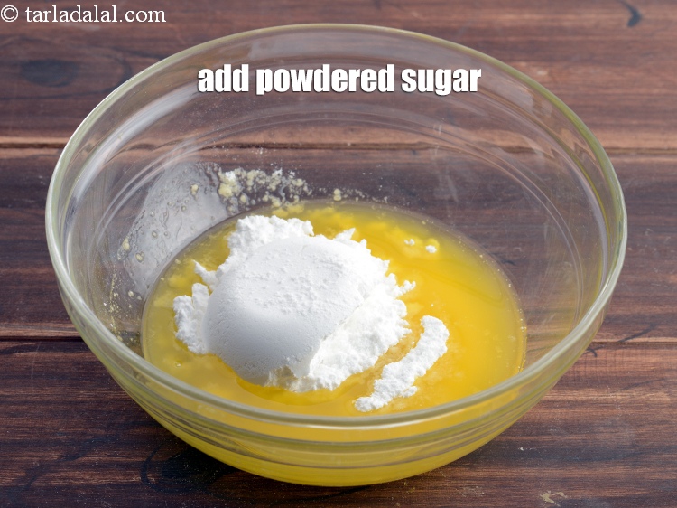 Step 13 – Add &frac12; cup <a href="https://www.tarladalal.com/glossary-powdered-sugar-280i">powdered sugar</a>.