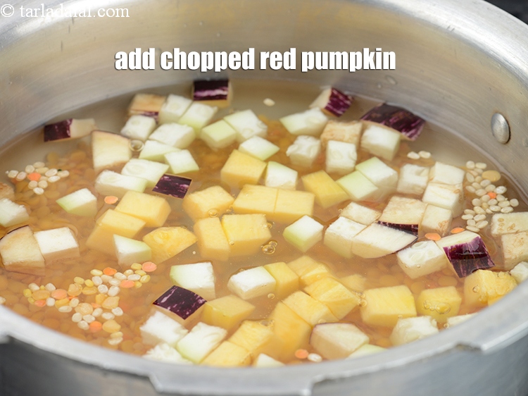 Step 12 – Add &frac14; cup&nbsp;<a href="https://www.tarladalal.com/glossary-chopped-red-pumpkin-809i">chopped red pumpkin (bhopla / kaddu)</a>.